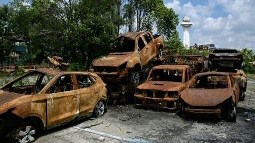 Torched vehicles lie piled near Nepal's old Parliament building in Kathmandu on September 8, 2026.