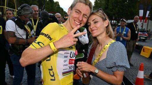 Tadej Pogacar (L) said he was looking forward to relaxing at home with his partner Urska Zigart (R) after winning a fifth Tour de France title