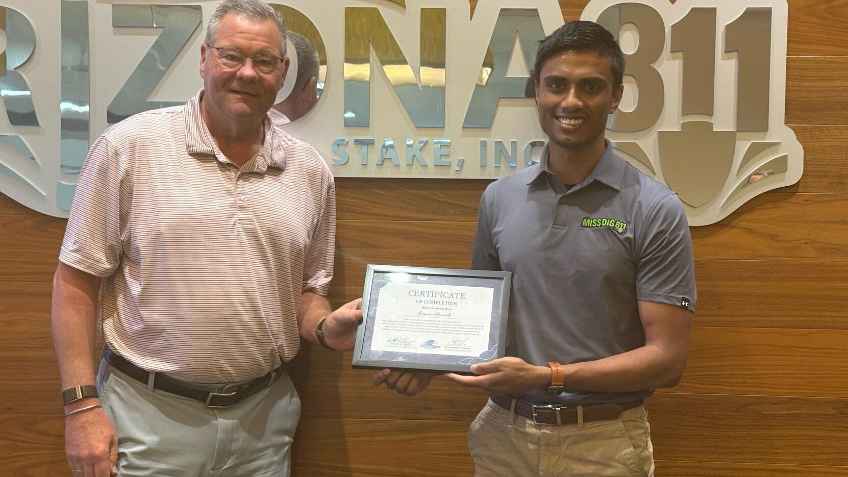 Bill Turner, President and CEO of Tennessee 811, presents Roni Ahmed, Director of Information Technology at MISS DIG 811, with his certificate of completion for the OCEAN (One Call Executive Apprentice Network) 811 Executive Apprentice Program.