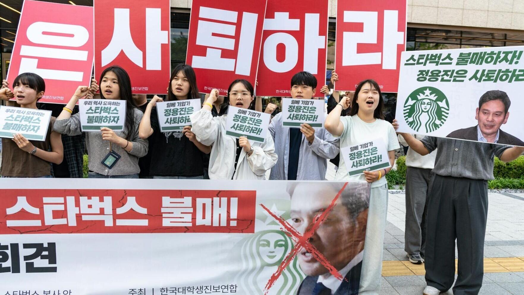 Protesters appear in front of Starbucks Korea headquarters in Seoul after the company launched its 'Tank Day' campaign, which sparked widespread backlash.