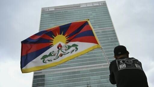 A protester holds a Tibetan flag in front of the United Nations in New York