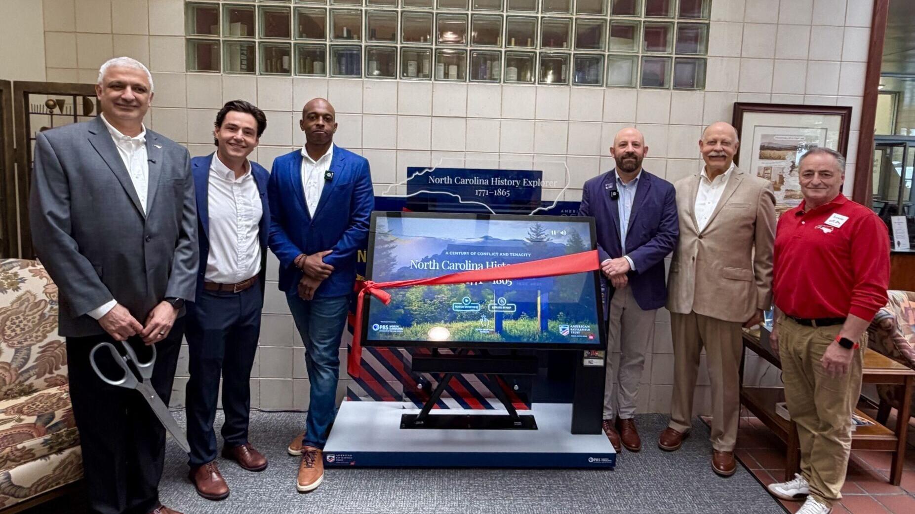 The first North Carolina History Explorer kiosk debuts at the I-77 South Visitor Center. (left to right): Wally Wazan (NC Dept. of Commerce), Luke McKnight (American Battlefield Trust), Eric Veal (Interactive Knowledge), Dan Brosz (America 250 NC), Bob ...