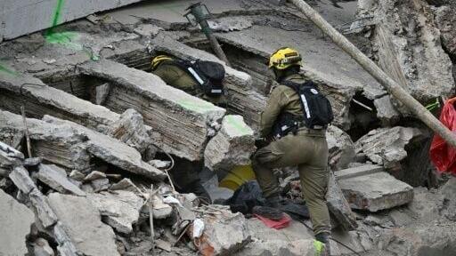 Rescuers work at a collapsed building after a 7.4- magnitude earthquake in Cali, Colombia, on August 16, 2026