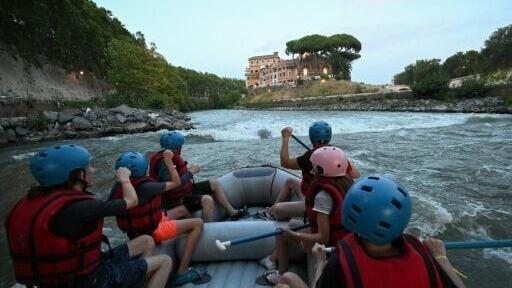 Overheated tourists are enjoying a break from the scorching heat by rafting on the Eternal City's Tiber River