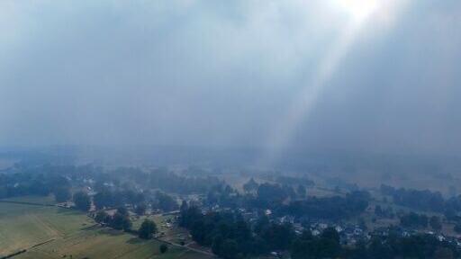 Smoke from the fire in Belgium hangs heavy over houses in Germany, close to the border