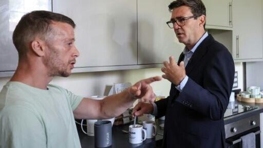 Britain's Prime Minister Andy Burnham makes a cup of tea during a visit to the homelessness charity Changing Lives in Newcastle