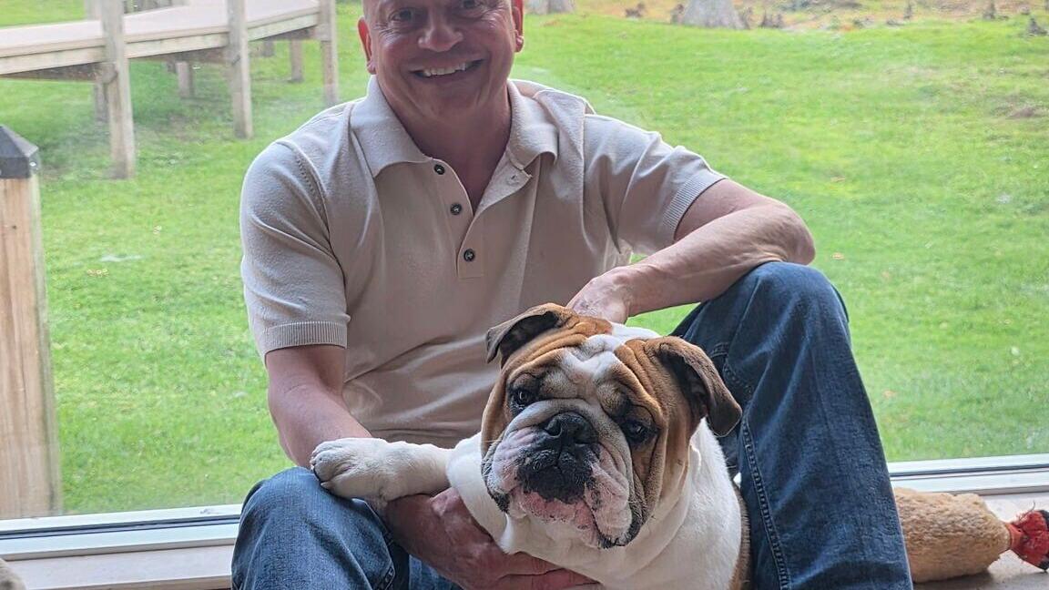 Author Alex Lucio with Baloo, the English bulldog whose namesake anchors the novel The Weight of a Dog.