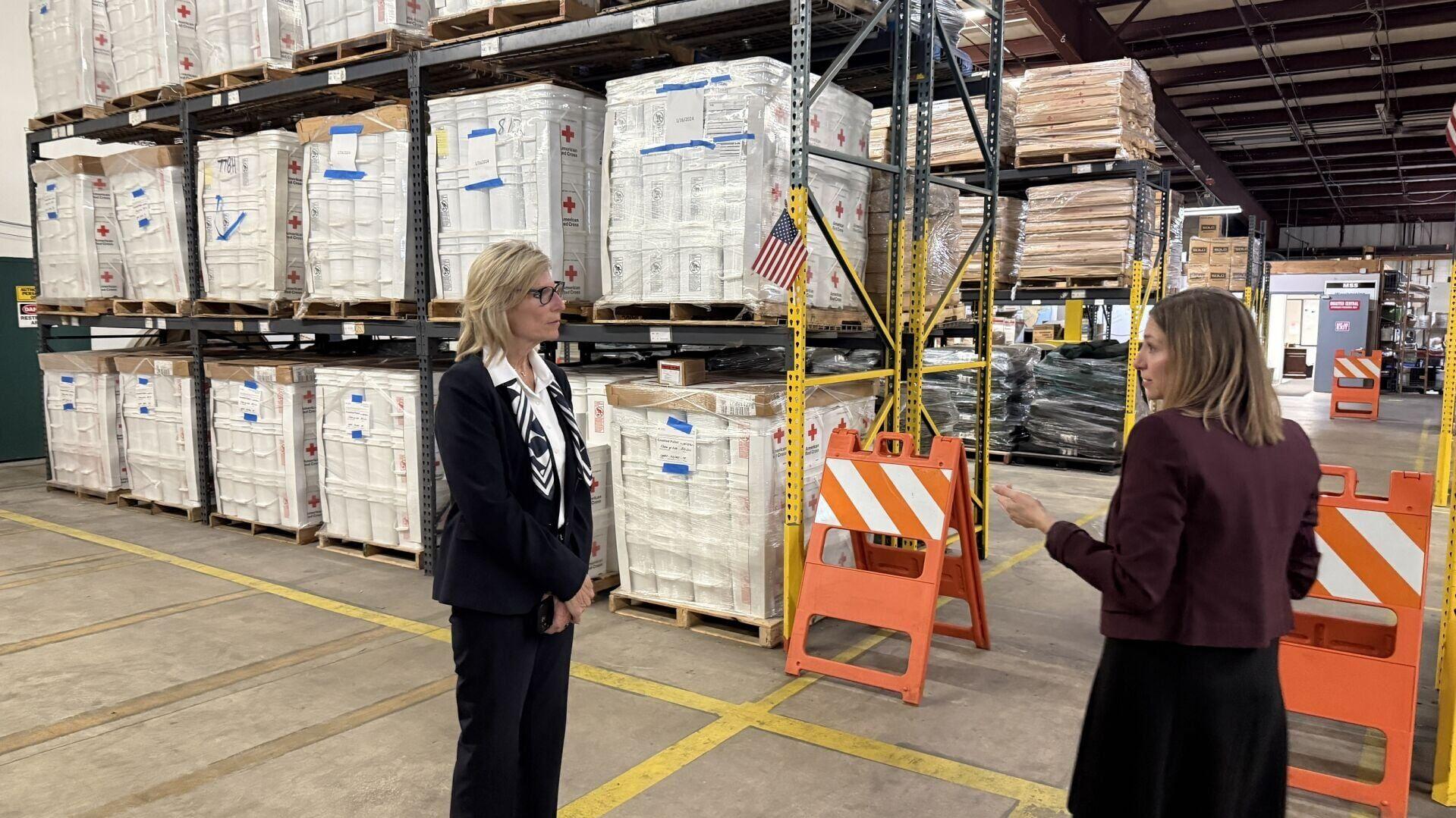 Jersey Central Power &amp; Light (JCP&amp;L) Vice President, Operations Patricia Mullin and American Red Cross Executive Director, Central New Jersey Region Kimberly Goetz tour the Red Cross' central N.J. warehouse