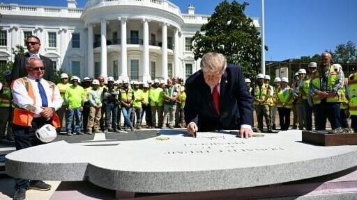US President Donald Trump left his mark at the construction site of a helipad on the South Lawn of the White House, the latest in his series of large-scale construction projects in Washington