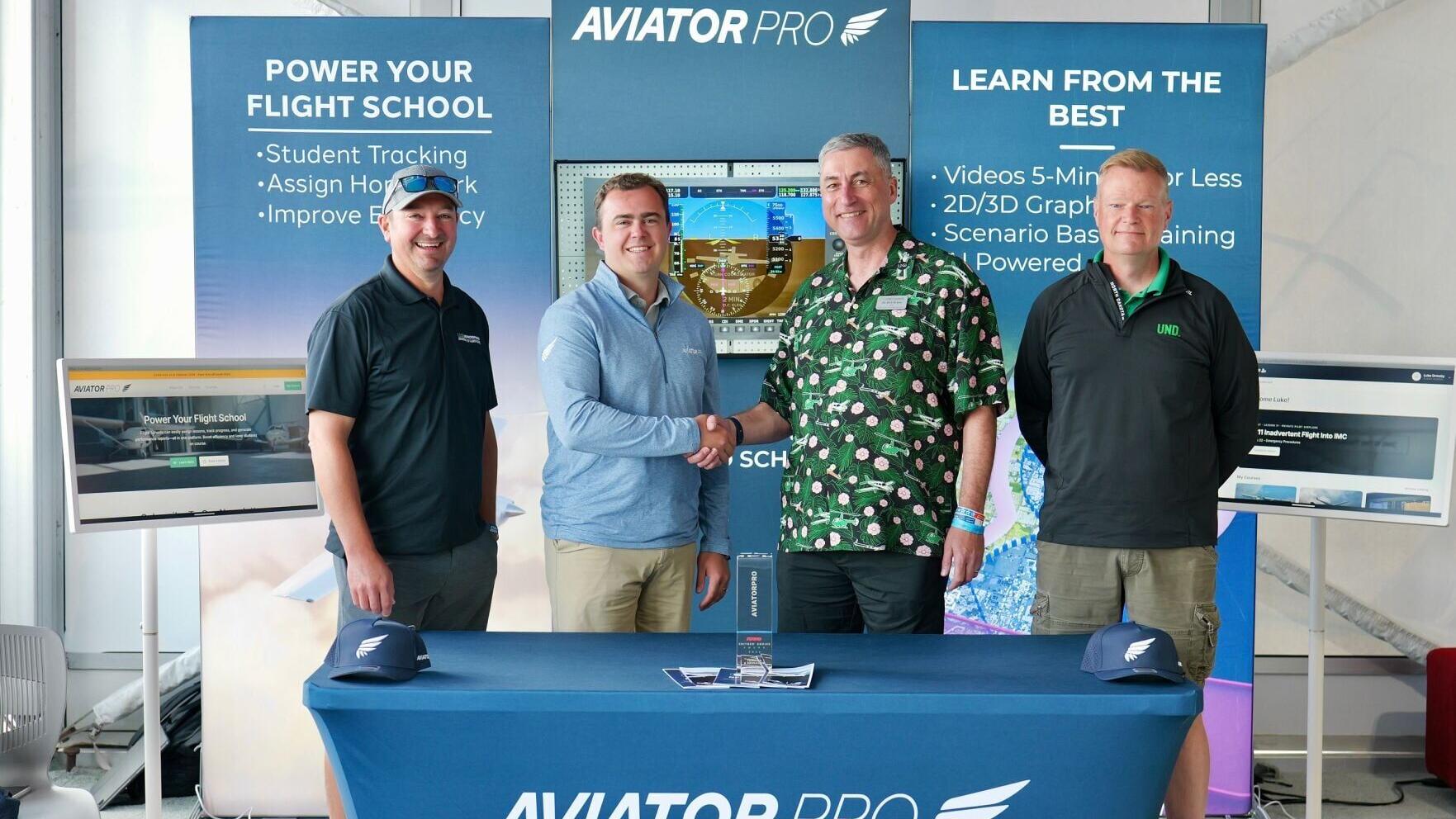 University of North Dakota and AviatorPro solidify a partnership with AviatorPro. Pictured are Chad Martin, Luke Ormsby, Dean Robert Kraus, and Jeremy Roesler.