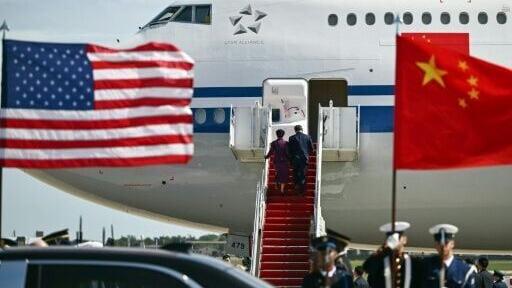 China's President Xi Jinping and his wife Peng Liyuan board an Air China plane upon departure from Joint Base Andrews in Maryland