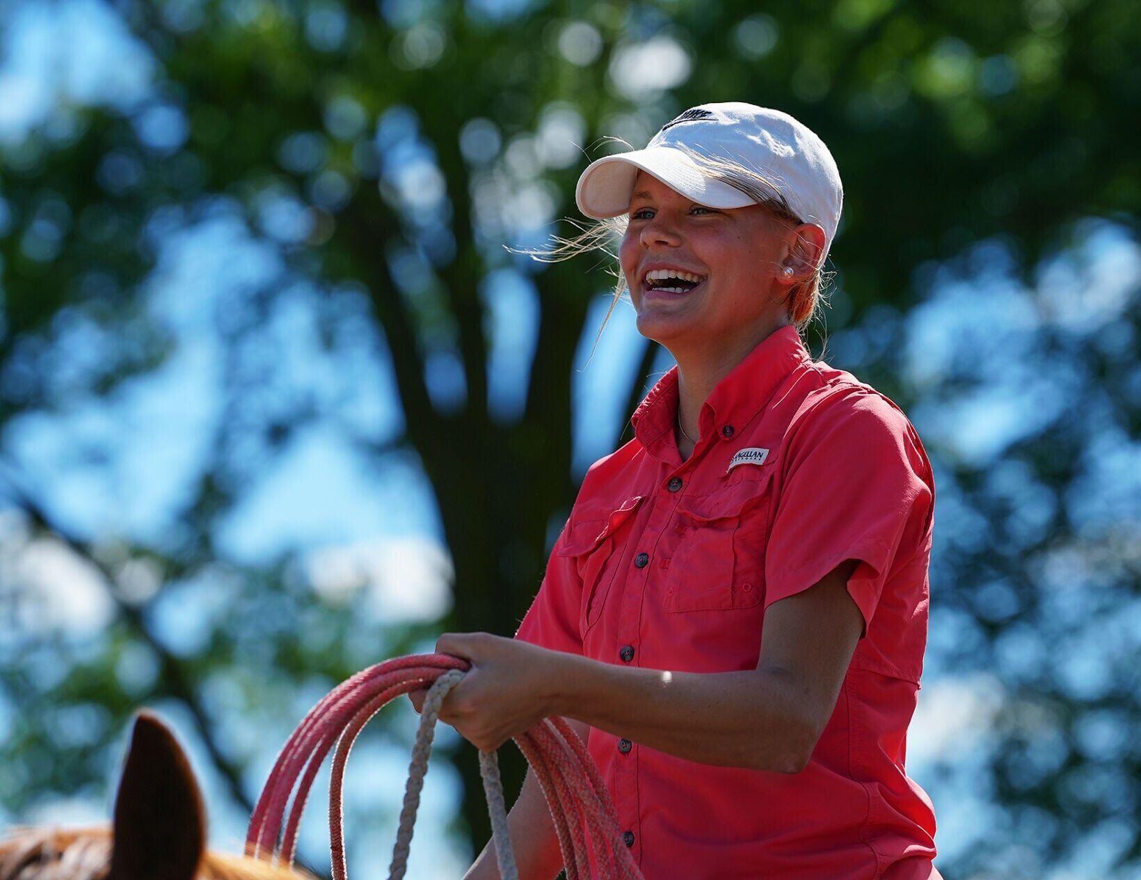 Kail Wood, 15, smiles as she rides her horse
