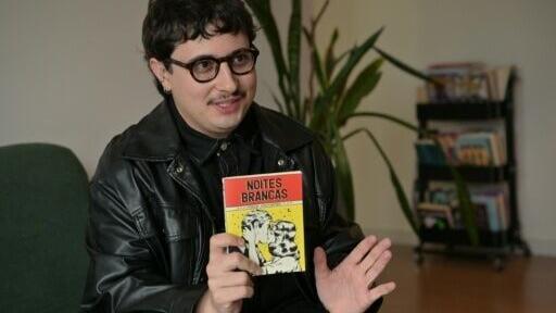 Brazilian book influencer Marcelo Nogueira speaks as he holds a pocket book version of "White Nights" by Russian writer Fyodor Dostoevsky, in Sao Paulo, Brazil