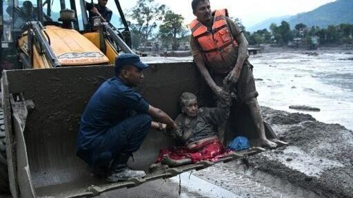 Rescuers use an excavator to transport a flood survivor, following flash floods and a landslide disaster in Nepal's Nuwakot district; outgoing UN chief Antonio Guterres has lashed out at oil companies at his swansong speech to the general assembly