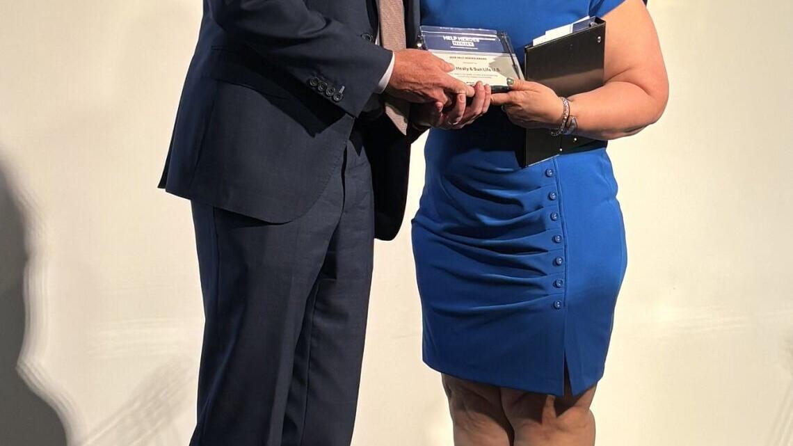David Healy, president of Sun Life U.S., receives HELP Hero award from HELP USA, presented by NYC Deputy Mayor for Health and Human Services, Dr. Helen Arteaga Landaverde.