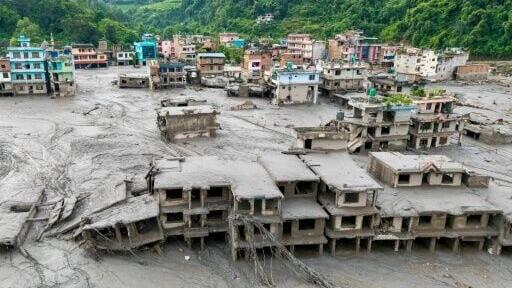 A tsunami-like wall of water and mud swept through villages and towns on Wednesday, leaving hundreds missing