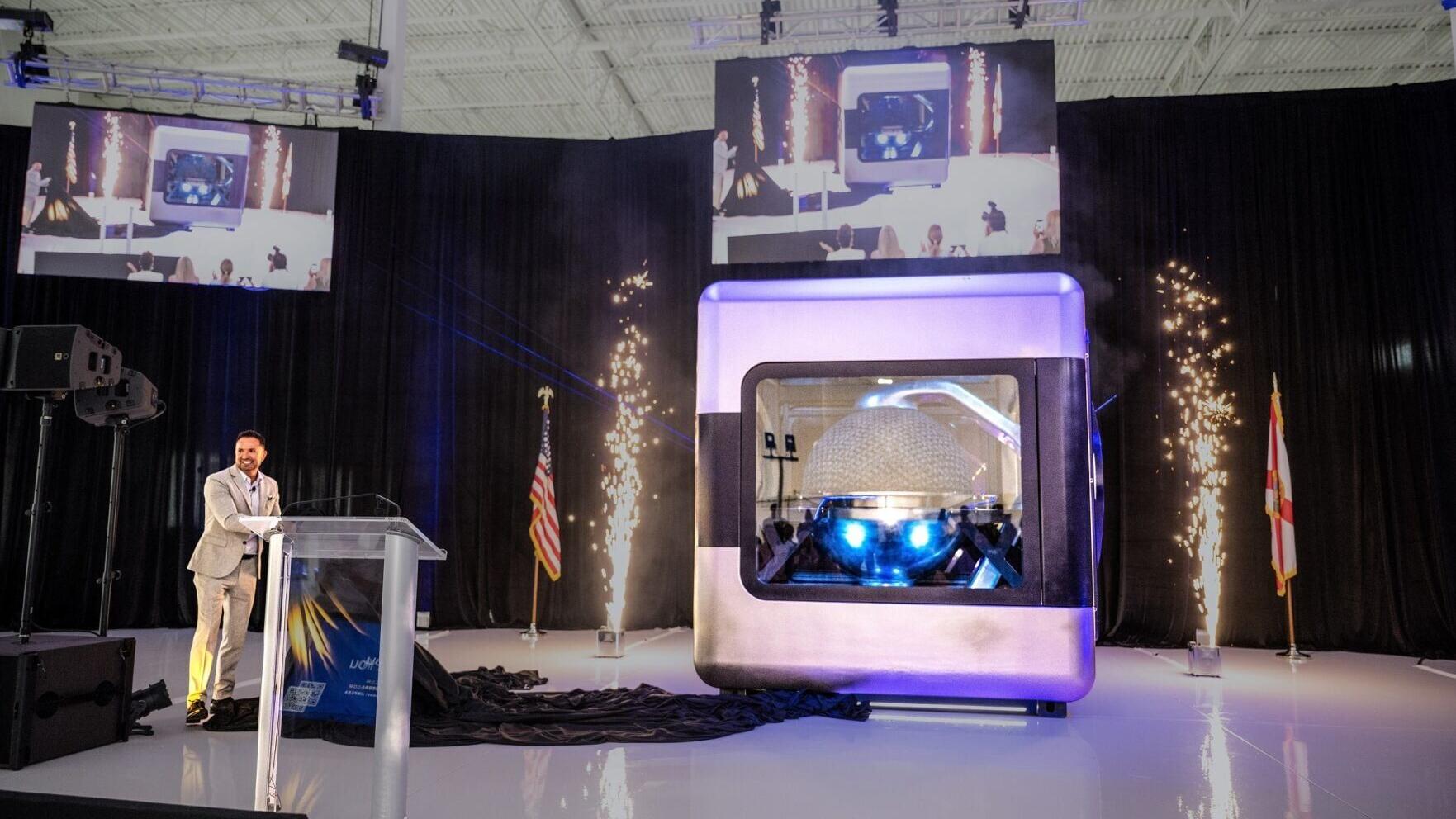 AMPERA Founder and CEO Brian Matthews pulls curtain revealing the first full-scale 3D printed reactor module, featuring a fully 3D printed silicon carbide reactor core and reactor pressure vessel at a celebratory event at the company’s innovation center...