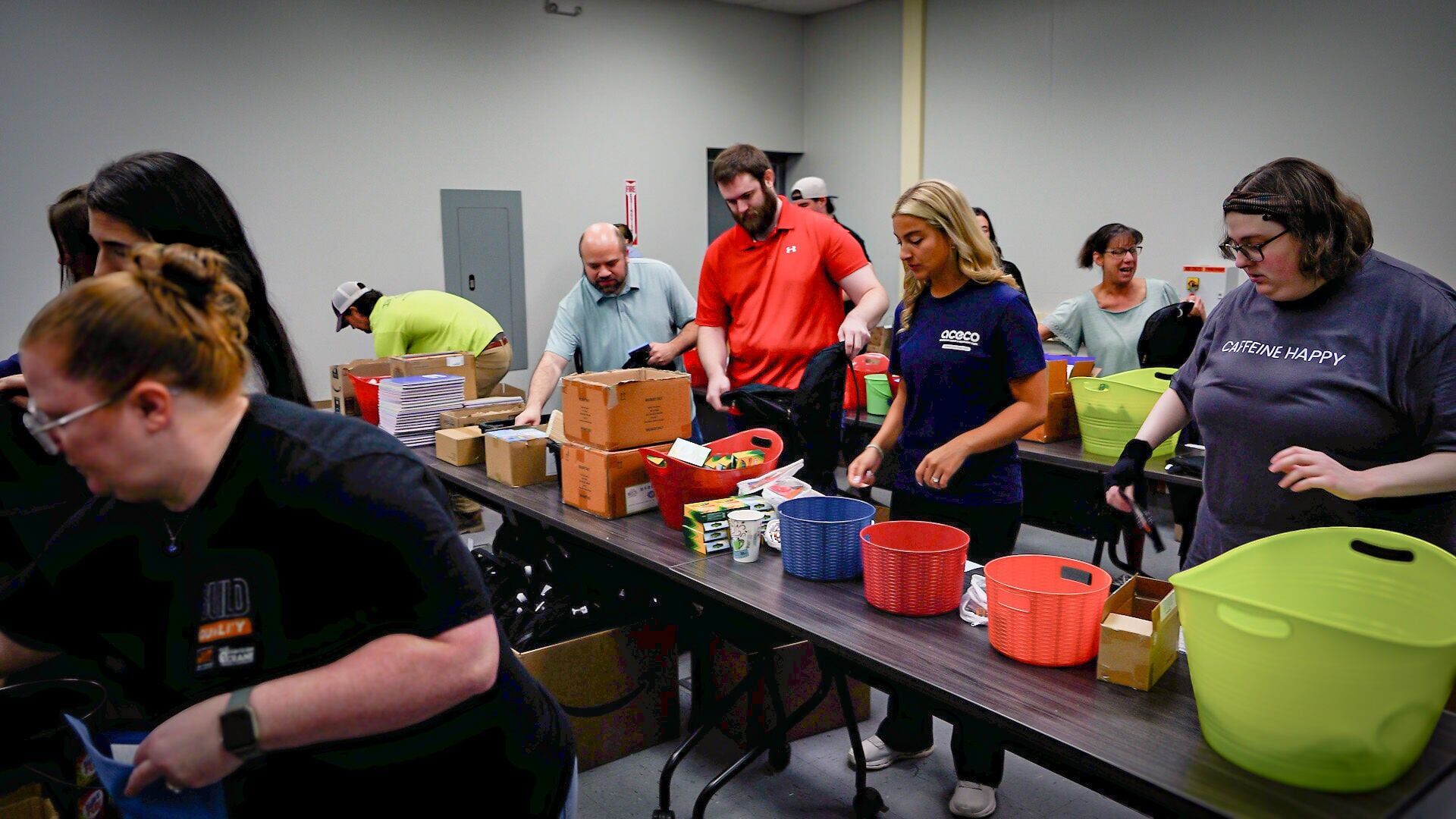 American Crane &amp; Equipment Corp. volunteers fill 250 backpack with school supplies