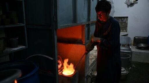 An Afghan goldsmith melting gold at a workshop in Fayzabad, in Afghanistan's northeastern Badakhshan province