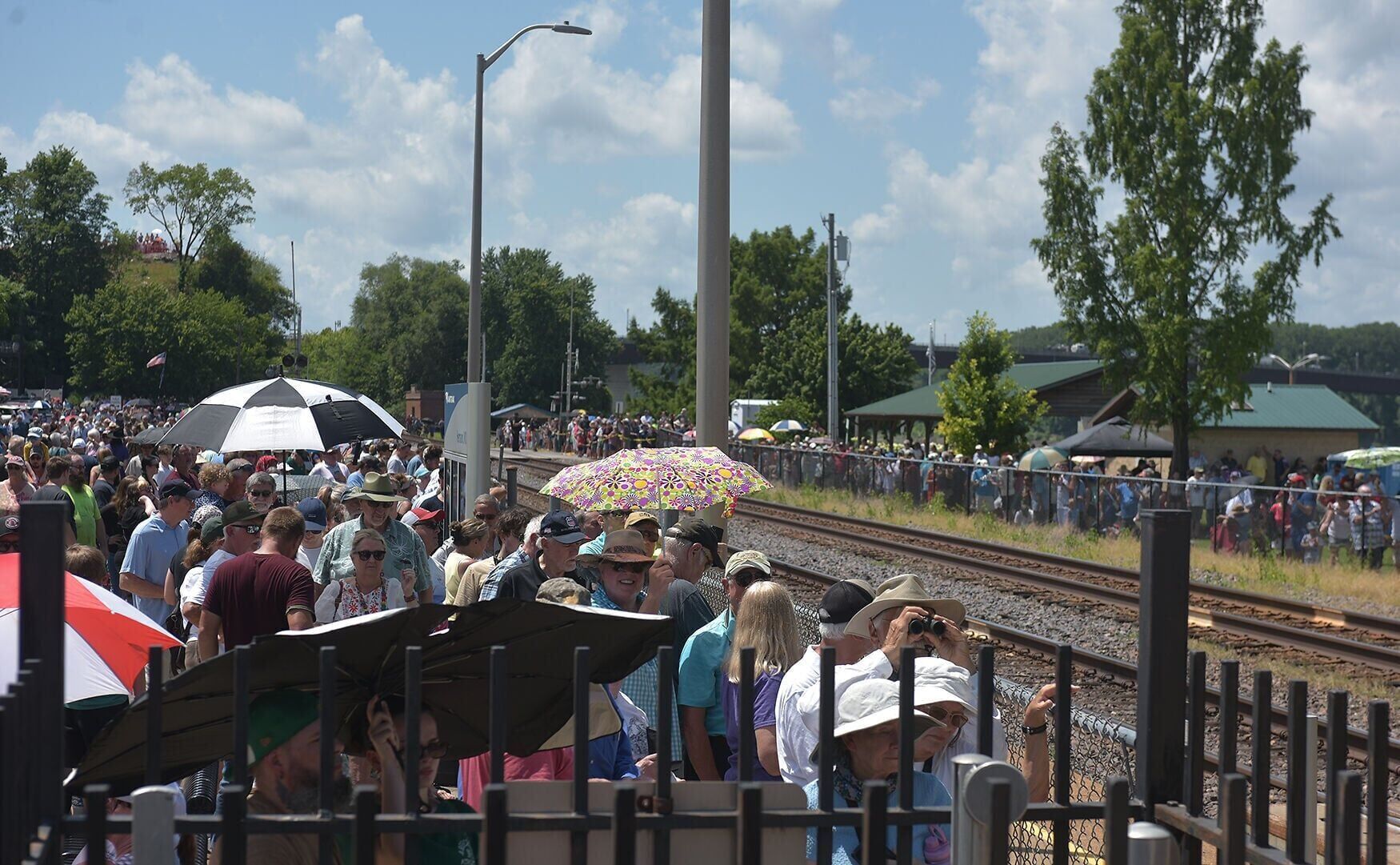 A crowd surrounds the Hermann Train Station
