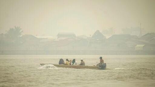 Indonesians on Borneo island say they acrid yellow haze has damaged their health
