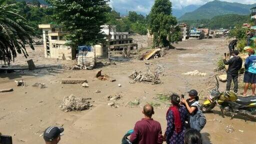 Homes were submerged in Nepal after a flood on the border with Tibet