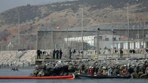 Migrants swam around the Ceuta border fence
