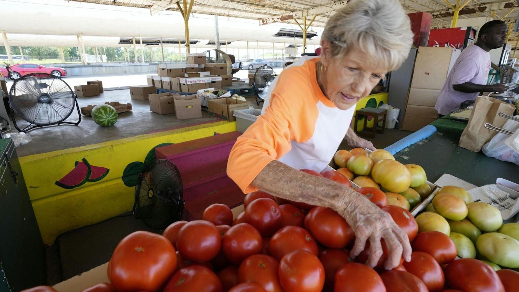 Fans can help circulate air, but on a hot day they do little for people working in a Mississippi farmer's market AP Photo/Rogelio V. Solis