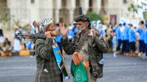 Supporters of the Houthi authorities hold weapons during a protest against Saudi Arabia in Sanaa on September 18