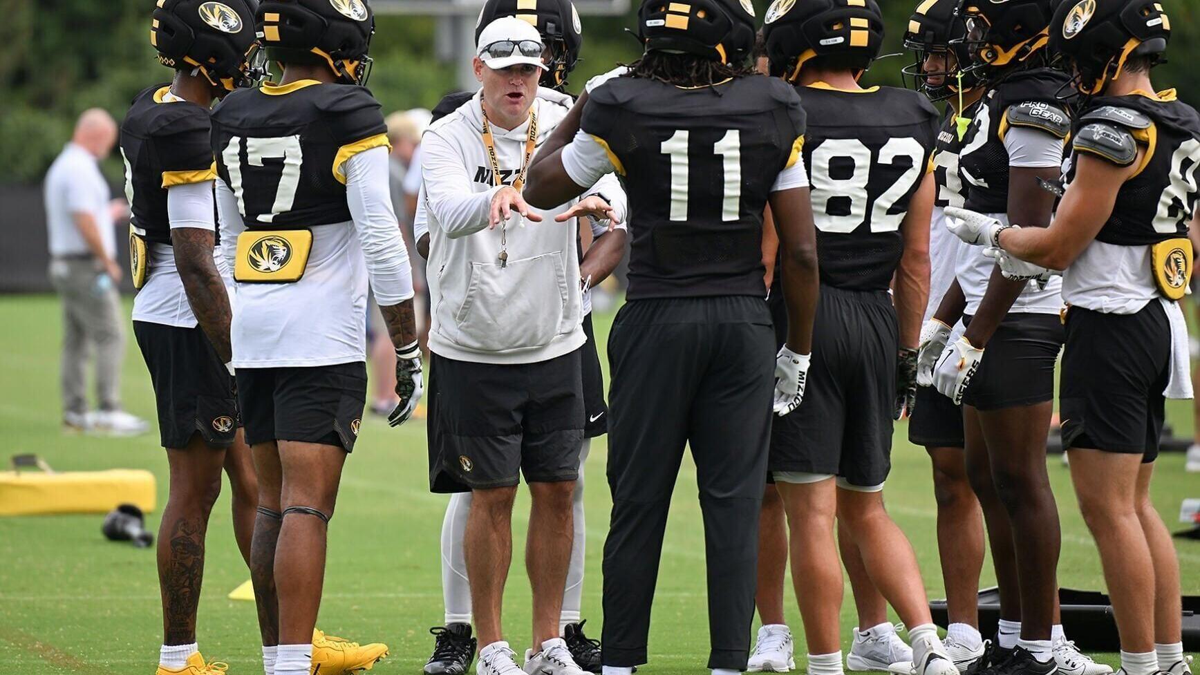 Wide receivers coach Jacob Peeler speaks with his players (copy)