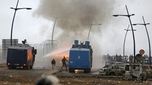 Moroccan security forces use water canon to disperse the crowds at the site of clashes near Fnideq on the Morocco-Spain border