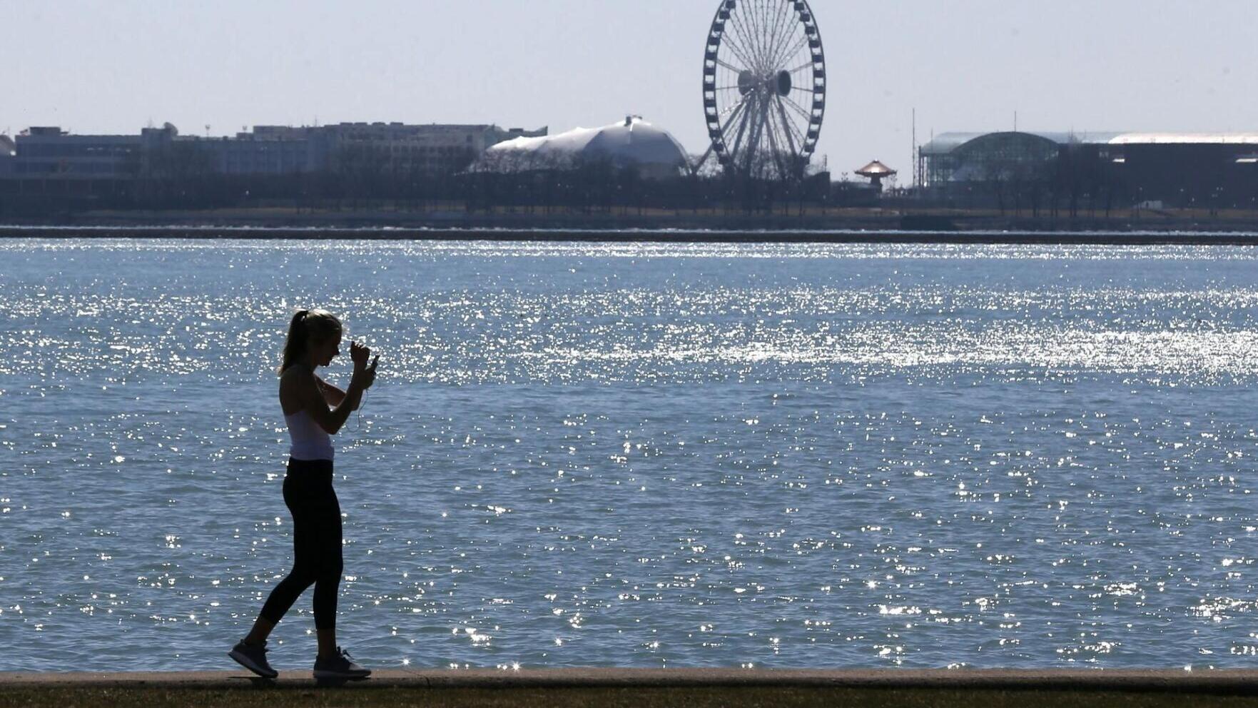A person walks the trail along Lake Michigan at Chicago's North Avenue Beach.