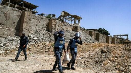 Members of a humanitarian NGO which primarily works to clear landmines and other explosive devices left behind by conflicts, prepare to detonate unexploded war-remnants in the Jobar suburb northeast of Damascus on August 12, 2026