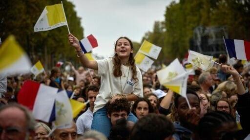 Helicopters could be heard flying overhead as worshippers waved small yeallow-and-white Vatican flags
