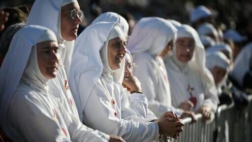 Nuns wait for the start of Sunday mass in Lourdes