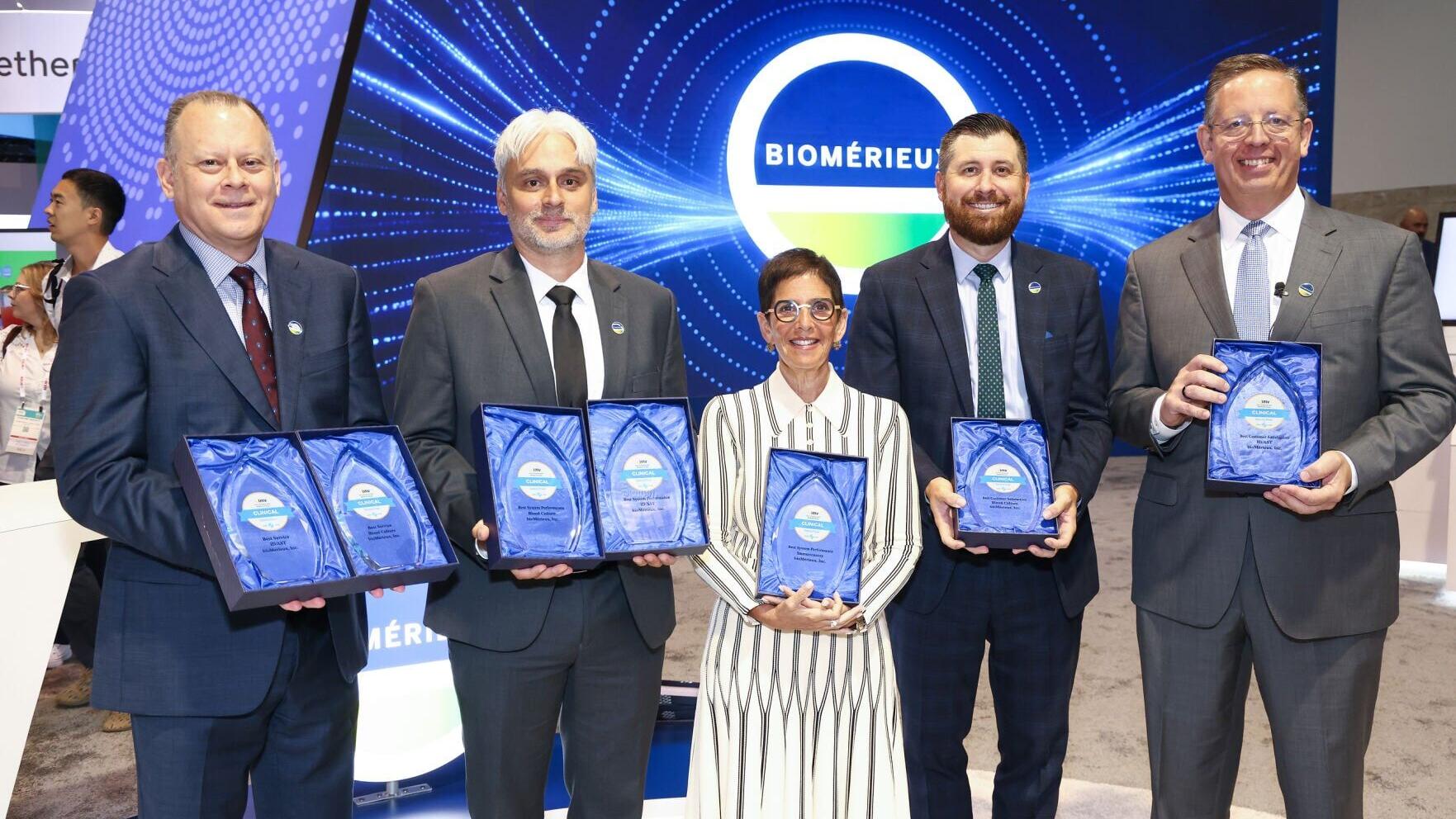 bioMérieux employees accepting the IMV ServiceTrak Awards at the ADLM conference in Anaheim on July 29.