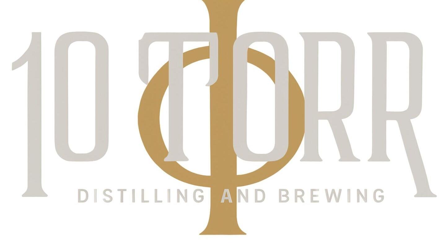 10 Torr Distilling and Brewing is located in Reno, Nevada, where the team uses vacuum distillation to reduce the atmospheric pressure in their process. The logo incorporates the symbol for Torr, a unit of precise pressure.