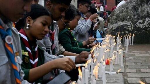 Nepali scouts light candles for flood victims during a vigil in Kathmandu on August 29, 2026