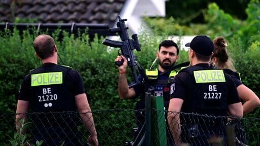 Police in an allotment complex in western Berlin where the presumed jihadist attacker was shot dead