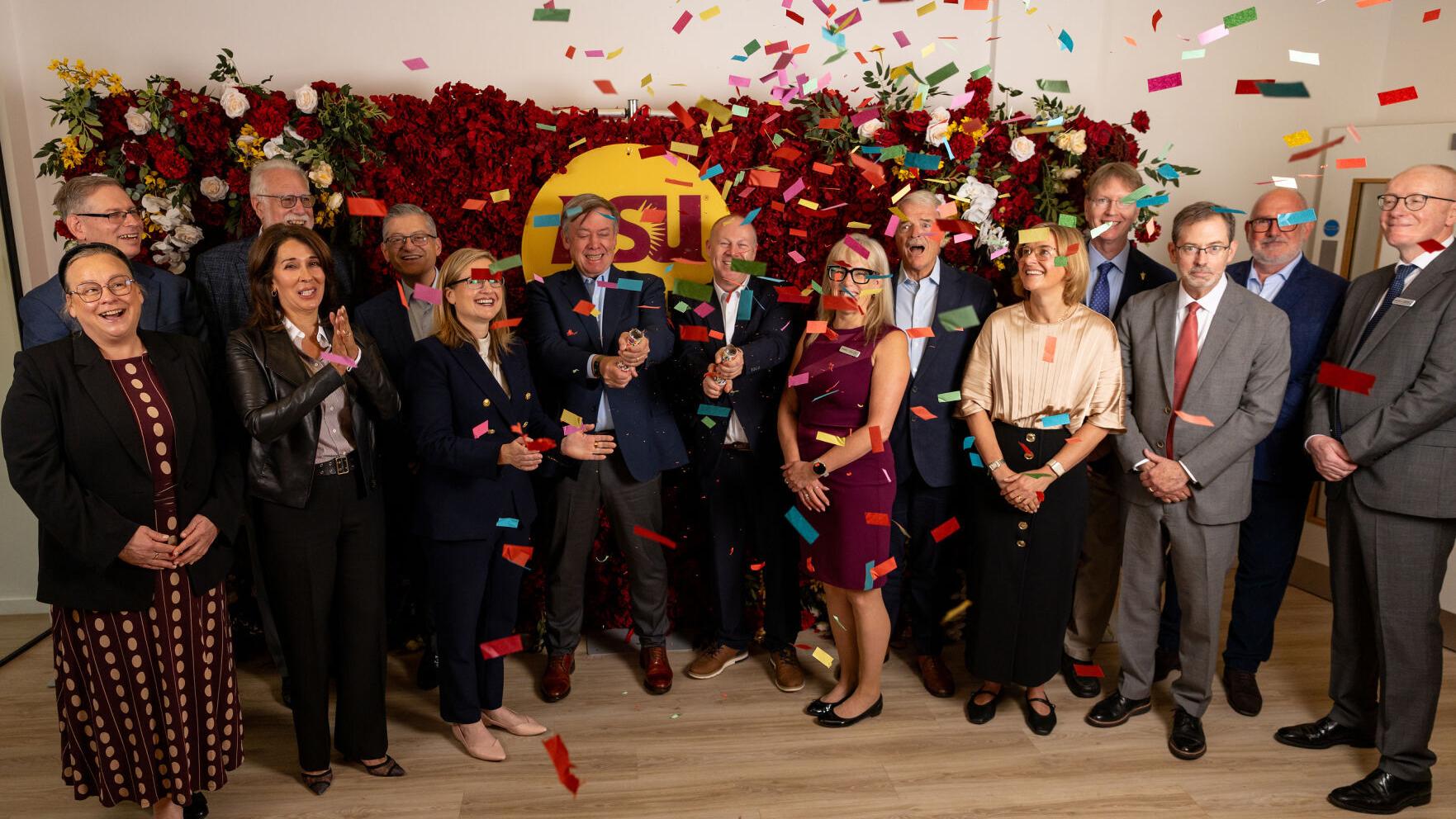 ASU President Michael Crow (center left) and ASU London Managing Director Michael Goodwin (center right) pop confetti canons alongside other ASU and ASU London leaders during a ceremony celebrating the opening of the ASU London Franklin Building in Lond...