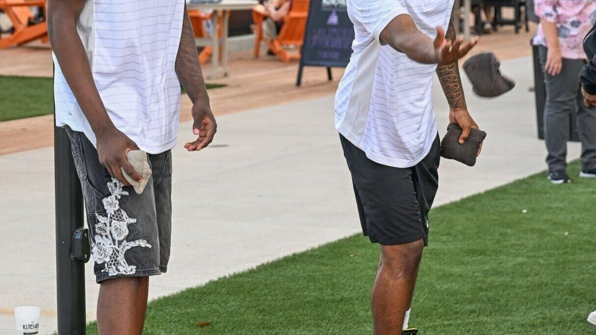 Mizzou basketball players Toni Bryant, left, and Jordan Crawford play cornhole