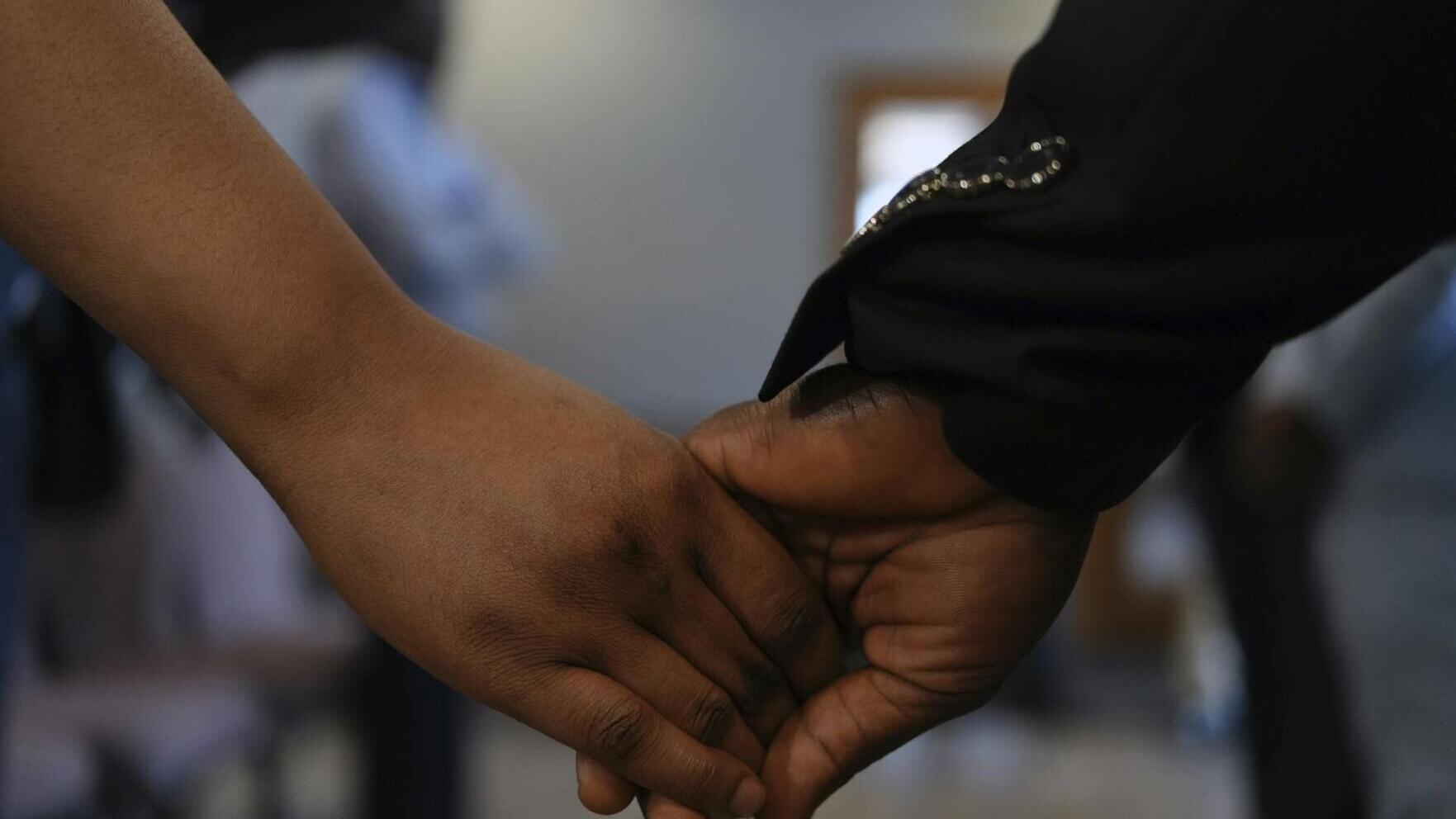Ushers at the First Haitian Evangelical Church of Springfield, Ohio, hold hands during Sunday service on Jan. 26, 2025.