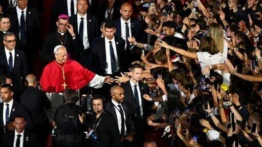 Pope Leo greets the crowd in Saint-Denis