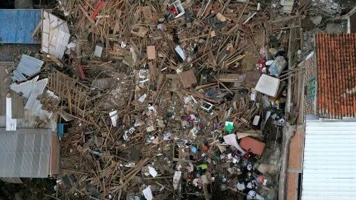 An aerial view shows houses destroyed by a 7.4-magnitude earthquake in Colombia, where rescuers race to search for people trapped in rubble