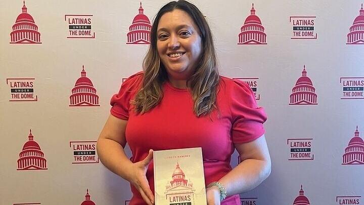 Author Lizbeth Ramírez poses with her new anthology, "Latinas Under the Dome: Illinois Edition," during a recent book launch. The book highlights the stories of 13 Latina leaders serving in elected office, legislative affairs, government relations, publ...