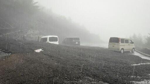 Vehicles buried by mud and debris after a landslide swept into the parking lot at Fifth Station of Mount Fuji's Fujinomiya Trail