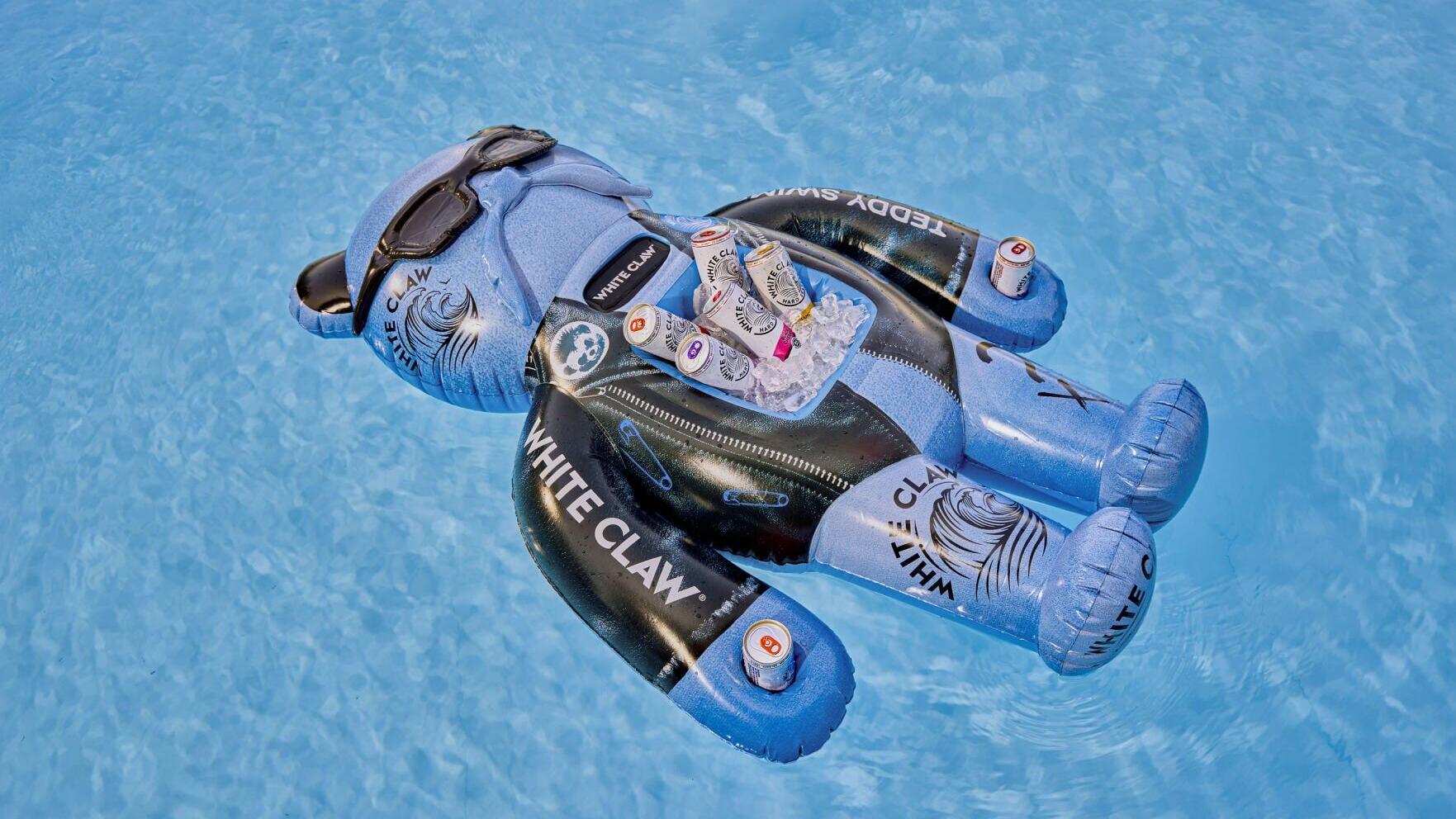 The Floatmate: White Claw® x Teddy Swims Limited-Edition Floatie is a go-to summer accessory with a built-in cooler, can holders and waterproof Bluetooth speaker to keep the Claws® cold and vibes going.