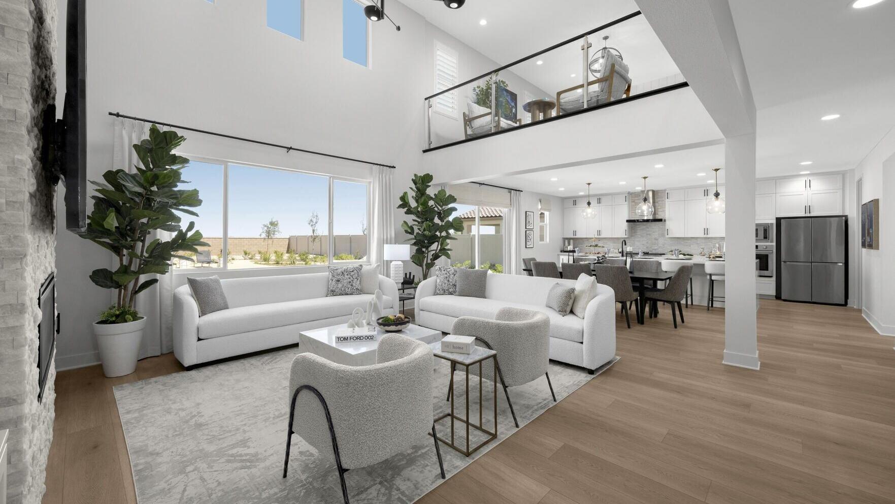 The spacious great room at Pacific Palacio highlights the community's open-concept home designs, featuring soaring ceilings, abundant natural light and seamless connections between the living, dining and kitchen areas. Contemporary finishes, a dramatic ...