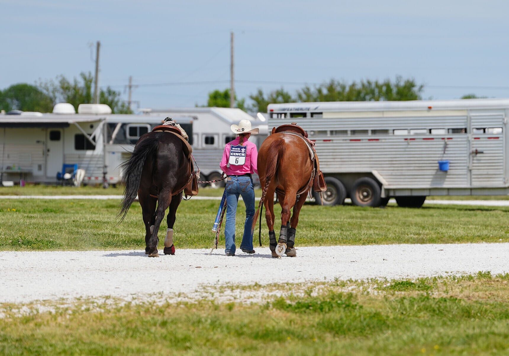 Kail Wood, 15, walks her horses Rico, left, and Skeet, right,