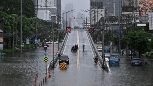 Motorists turn around from an overpass next to flood waters along Phetchaburi Road in Bangkok on September 26, 2026